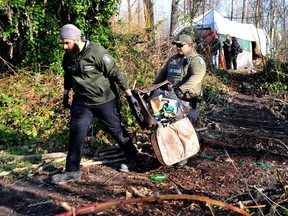 Vancouver park rangers take away items from a squatters' encampment in Vanier Park near Kits Point on Wednesday morning.