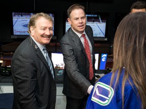 John Garrett (left) and play-by-play man John Shorthouse greet a fan at Rogers Arena.
