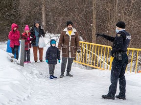 A family of five enters Canada from the U.S. at Roxham Road.