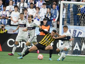 Real Espana midfielder Jhow Benavidez (10) challenges Vancouver Whitecaps FC midfielder Andres Cubas (20) during the first half at BC Place Stadium.