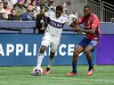Vancouver Whitecaps forward Cristian Dajome  controls the ball against FC Dallas defender Sebastien Ibeagha during the first half at B.C. Place March 11, 2023.