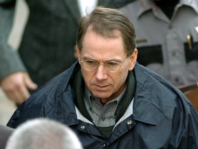 Terry Nichols enters the Pittsburg County Courthouse with officers on the second day of jury selection in his trial March 2, 2004 in McAlester, Oklahoma.