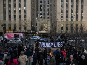 Anti-Trump demonstrators protest outside the Manhattan District Attorney's office in New York on March 21, 2023.