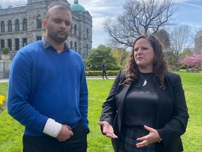 Uber driver Aman Sood (left) and B.C. Federation of Labour President Sussane Skidmore at the B.C. legislature in Victoria on April 26, 2023.