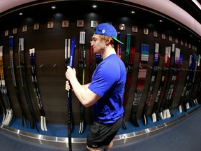 Nils Hoglander check his game sticks before game against the New Jersey Devils on March 15, 2022 at Rogers Arena.