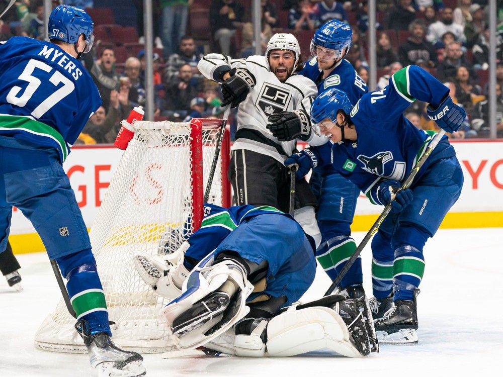 Alex Iafallo #19 of the Los Angeles Kings celebrates after knocking the puck past goalie Thatcher Demko of the Vancouver Canucks for a goal as Ethan Bear #74 and Elias Pettersson #40 of the Vancouver Canucks try and help defend the play during the second period.