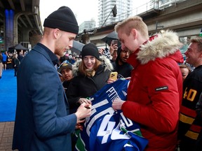 Elias Pettersson of the Vancouver Canucks meets with fans before his NHL game against Calgary at Rogers Arena on April 8 in Vancouver.