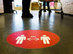 Physical distancing sign on the floor grocery store pandemic public health regulations getty images stock photo