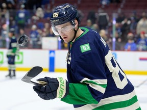 Nils Aman of the Vancouver Canucks flips the puck during warm-up prior to their NHL game against the St. Louis Blues at Rogers Arena on Dec. 19, 2022. Photo: Derek Cain/Getty Images