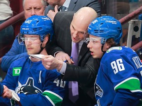 Canucks coach Rick Tocchet gives Andrei Kuzmenko (right) directives during game against the Flyers on Feb. 18 at Rogers Arena.
