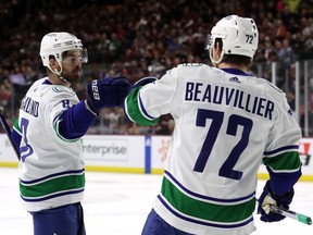 Conor Garland, left, of the Vancouver Canucks celebrates scoring a goal with Anthony Beauvillier of the Vancouver Canucks during the first period at Mullett Arena on April 13, 2023 in Tempe, Arizona.