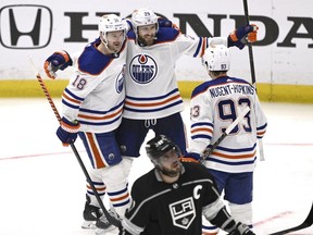 Edmonton Oilers' Leon Draisaitl (29) celebrates with Zach Hyman (18) and Ryan Nugent-Hopkins after his goal, as Los Angeles Kings' Anze Kopitar skates past during the second period in Game 6 of an NHL hockey Stanley Cup first-round playoff series in Los Angeles on Saturday, April 29, 2023.