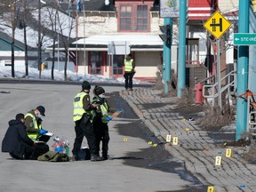 Police officers investigate the scene of a fatal incident, Tuesday, March 14, 2023 in Amqui Que. Two people were killed and nine others were injured Monday afternoon when a pickup truck plowed into pedestrians who were walking beside a road in the eastern Quebec town of Amqui. THE CANADIAN PRESS/Jacques Boissinot