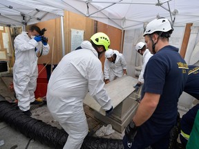 This photo taken and handout on July 11, 2019 by the Vatican Media shows the opening of one of two tombs within the Vatican's grounds in the Teutonic Cemetery on July 11, 2019, as part of a probe into the case of Emanuela Orlandi.