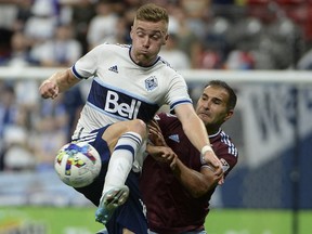 Vancouver Whitecaps midfielder Julian Gressel out-muscles Colorado Rapids defender Steven Beitashour during last August's game at B.C. Place.