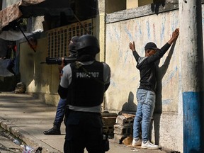 A man is arrested by Haitian police in the Turgeau commune of Port-au-Prince, Haiti on April 24, 2023, as gangs take over areas of Haiti. More than 530 people have been killed this year in gang violence in Haiti, the United Nations said March 21, 2023 with many killed by snipers shooting victims at random.