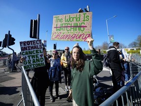 Animal rights protesters are seen near Aintree Racecourse before the Grand National horse race in Liverpool, England, Saturday, April 15, 2023.