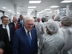 Germany President Frank-Walter Steinmeier laughs as he jokes with employees during a tour of fuel cell stack manufacturer, Cellcentric Canada, in Burnaby, B.C., Tuesday, April 25, 2023.