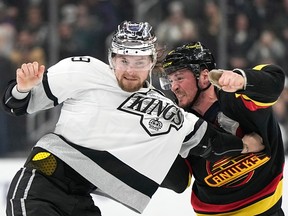 Los Angeles Kings right wing Adrian Kempe, left, and Vancouver Canucks centre J.T. Miller fight during the second period on Monday, April 10, 2023, in Los Angeles.