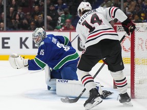 Vancouver Canucks goalie Thatcher Demko stops Chicago Blackhawks' Boris Katchouk during the first period of an NHL hockey game in Vancouver, on Thursday, April 6, 2023.