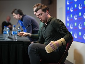 Vancouver Canucks left-winger Tanner Pearson, who broke his hand during a game last November, stands to leave after the NHL hockey team's end of season news conference, in Vancouver, on Saturday, April 15, 2023.
