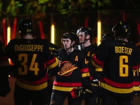 Vancouver Canucks' Quinn Hughes (centre) addresses the fans after beating the Calgary Flames in their final NHL hockey home game of the year on April 8, 2023.