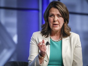 Alberta Premier Danielle Smith gestures as she speaks at an economic forum in Calgary,Tuesday, April 18, 2023. Smith is declining to say whether she stands by or disavows earlier comments proposing Albertans pay out of pocket for medically insured services as a way to keep the health-care system sustainable.