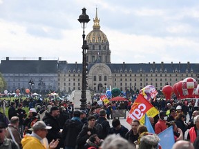 Demonstrators gather in front of the Hotel des Invalides as they take part in a day of action after the government pushed a pensions reform through parliament without a vote, using the article 49.3 of the constitution, in Paris on April 6, 2023.
