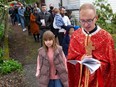 Father Mykhailo Ozorovych leads the procession of the holy shroud as part of Easter services at Holy Eucharist Cathedral in New Westminster. Many recent arrivals from Ukraine are members of the congregation at the Catholic church.