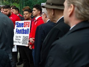 SFU Red Leafs QB Keyshaun Dorsey (centre right) joins current and past players of the SFU football program gather at BC Supreme Court in Vancouver, BC Thursday, April 13, 2023. SFU cancelled the football program last week and a group including alumni are asking the courts to halt the cancellation.