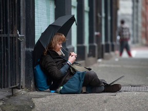 A man smokes from a drug pipe on Columbia St. in Vancouver's downtown eastside.(Photo by Jason Payne/ PNG)
