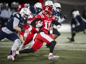 Simon Fraser University Red Leafs Robert Meadors runs the ball downfield while trying to avoid being tackled by Luke Burton-Krahn of the cross-town rivals the UBC Thunderbirds during the 34th Shrum Bowl at SFU Friday, December 2, 2022.