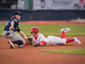 Canadians outfielder Garrett Spain slides under the tag made by UBC Infielder Mike Fitzsimmons while stealing second base during an exhibition game between the UBC Thunderbirds and the Vancouver Canadians at Nat Bailey Stadium  on April 6, 2022.
