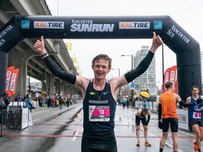 John Gay celebrates after winning the 2023 Sun Run in Vancouver on April, 16, 2023.