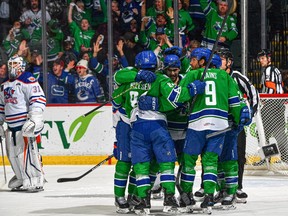 The Abbotsford Canucks celebrate a goal during Game 2 of their opening round Calder Cup playoff series against the Bakersfield Condors at the Abbotsford Centre on Friday, April 21, 2023. The Canucks won 4-2 to advance to the second round of the AHL playoffs.