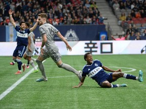 CF Montreal defender Joel Waterman holds Vancouver Whitecaps FC defender Ali Ahmed and during the first half at BC Place April 1, 2023..