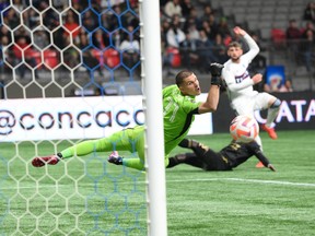 Apr 5, 2023; Vancouver, British Columbia, CAN;  Los Angeles FC goalkeeper John McCarthy (77) reaches for the ball after a shot by the Vancouver Whitecaps FC during the first half at BC Place. Mandatory Credit: Anne-Marie Sorvin-USA TODAY Sports
