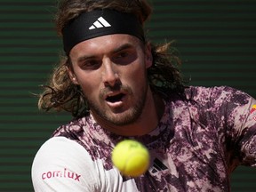 Stefanos Tsitsipas, of Greece, returns the ball to Taylor Fritz, of the United States, during their Monte Carlo Tennis Masters quarterfinals match in Monaco, Friday, April 14, 2023. Top-seeded men's players Tsitsipas of Greece and Andrei Rublev of Russia are joining Bjorn Borg's Team Europe for this year's Laver Cup in Vancouver.