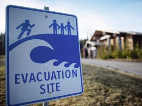 A tsunami evacuation site sign is shown on high ground near the House of Huuayaht in the Village of Anacla in Pachena Bay. JONATHAN HAYWARD, THE CANADIAN PRESS