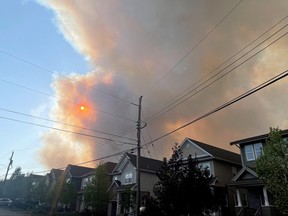 Smoke from the Tantallon wildfire rises over houses in nearby Bedford, N.S., May 28, 2023.
