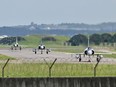 French-made Mirage 2000 fighter jets taxi on a runway in front of a hangar at the Hsinchu Air Base in northwestern Taiwan. China has been conducting military exercises around Taiwanese air space almost daily for months.