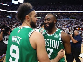 Derrick White #9 and Jaylen Brown #7 of the Boston Celtics react after defeating the Miami Heat 104-103 in game six of the Eastern Conference Finals at Kaseya Center on May 27, 2023 in Miami, Florida.