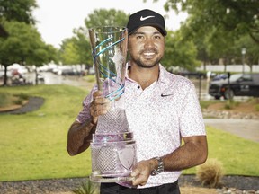Jason Day poses with the winner's trophy during the final round of the AT&T Byron Nelson golf tournament.