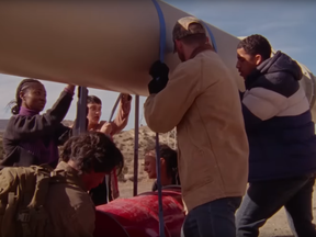 A group of eco-terrorists attach a barrel of explosives to an oil pipeline, in a scene from the film "How To Blow Up A Pipeline."