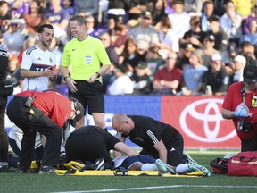 Vancouver Whitecaps midfielder Ali Ahmed lays on the field at Starlight Stadium.