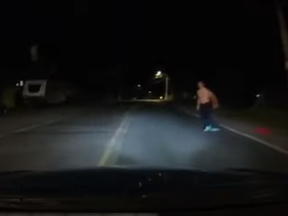 A grainy YouTube video shows a teenager approaching a vehicle before throwing himself on the hood of the car.