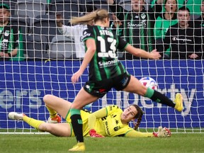 Western United FC goalkeeper Hillary Beall dives as teammate Danielle Steer kicks the ball during the women’s Liberty A-League Grand Final football match against Sydney FC at Commbank Stadium in Sydney on April 30, 2023.