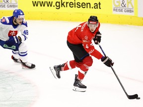 Slovakia’s Viliam Cacho (L) and Austria’s David Reinbacher vie for the puck during the ice hockey match between Austria and Slovakia on May 4, 2023 in Kapfenberg, Austria.