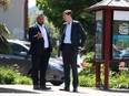 Premier David Eby and BC NDP candidate Ravi Parmar walk along Goldstream Ave. as they visit shops and talk to locals while out in Langford, B.C., on May 25, 2023.