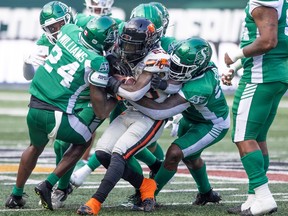 Saskatchewan Roughriders make a tackle on BC Lions running back Taquan Mizzell